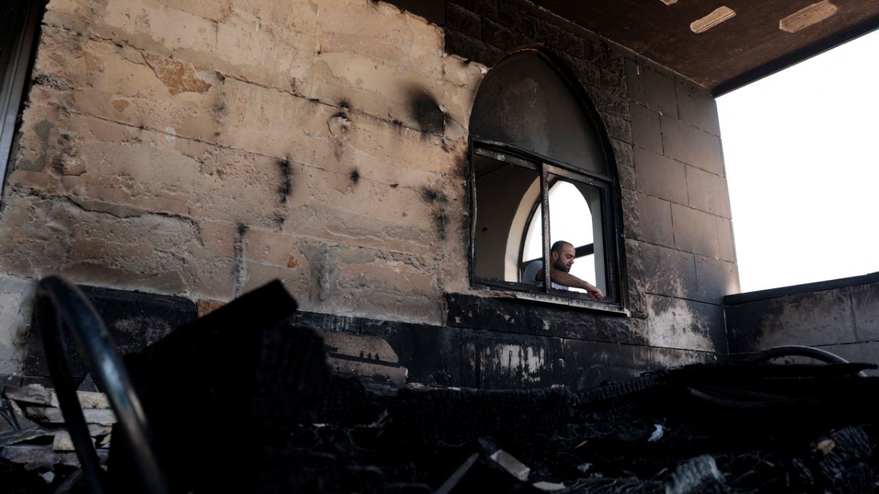 A Palestinian man inspects the damage at a mosque, which Palestinians say was damaged by Israeli settlers, in Qusra near Nablus, in the Israeli-occupied West Bank, Sunday. (Reuters-Yonhap)