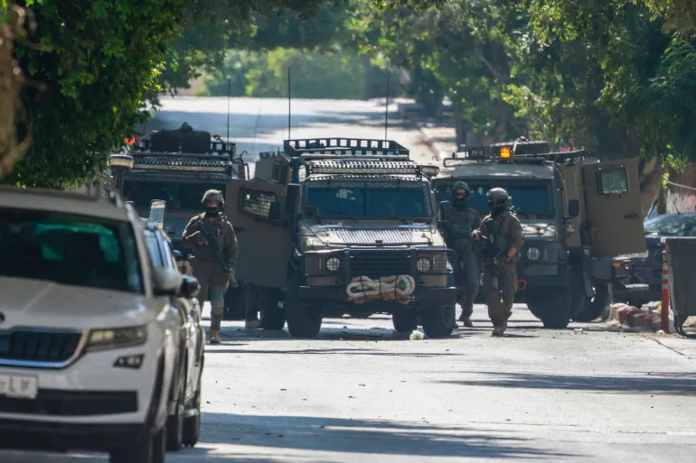 Israeli soldiers surround a hospital in Nablus