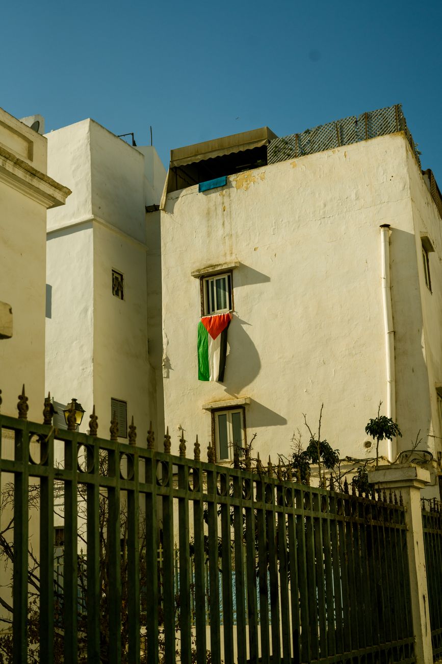 building with palestinian flag in urban setting