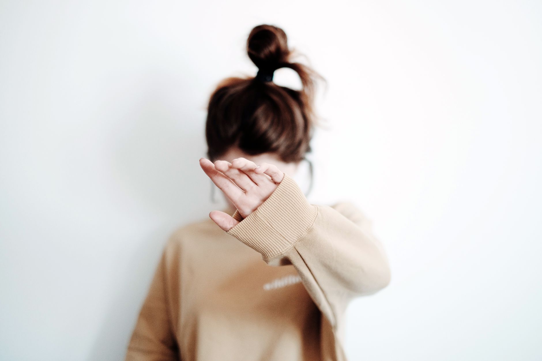 photo of a girl hiding her face